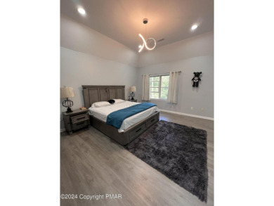 Discover this ultra modern, newly renovated 4-bedroom, 2.5 bath on Country Club of the Poconos Golf Course in Pennsylvania - for sale on GolfHomes.com, golf home, golf lot