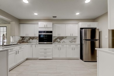 Discover this light-filled and spacious end-unit condo in the on Feather Sound Country Club in Florida - for sale on GolfHomes.com, golf home, golf lot