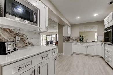 Discover this light-filled and spacious end-unit condo in the on Feather Sound Country Club in Florida - for sale on GolfHomes.com, golf home, golf lot