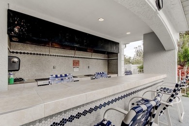 Discover this light-filled and spacious end-unit condo in the on Feather Sound Country Club in Florida - for sale on GolfHomes.com, golf home, golf lot