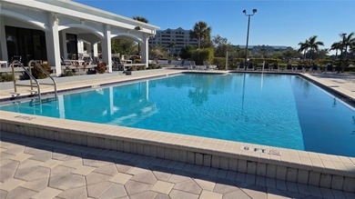Discover this light-filled and spacious end-unit condo in the on Feather Sound Country Club in Florida - for sale on GolfHomes.com, golf home, golf lot