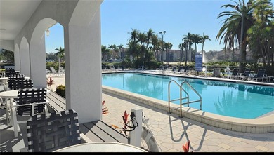 Discover this light-filled and spacious end-unit condo in the on Feather Sound Country Club in Florida - for sale on GolfHomes.com, golf home, golf lot