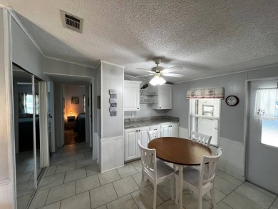 Welcome to your dream oasis! This stunning 2-bedroom, 2-bathroom on Lake Henry Golf Club in Florida - for sale on GolfHomes.com, golf home, golf lot
