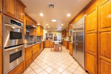 Welcome to your dream home! Nestled on an expansive corner lot on Elk City Golf and Country Club in Oklahoma - for sale on GolfHomes.com, golf home, golf lot