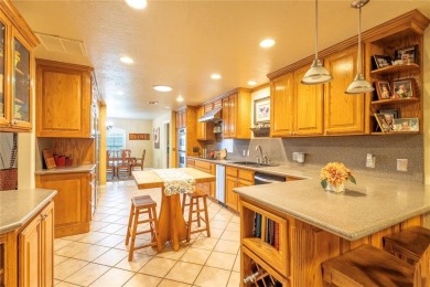 Welcome to your dream home! Nestled on an expansive corner lot on Elk City Golf and Country Club in Oklahoma - for sale on GolfHomes.com, golf home, golf lot
