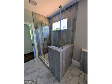 A golfer's paradise! This 4-bedroom, 3-bathroom home with 9' on Indian Creek Golf Club in Georgia - for sale on GolfHomes.com, golf home, golf lot