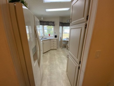 This well cared for home is furnished and includes the golf cart on Lake Fairways Country Club in Florida - for sale on GolfHomes.com, golf home, golf lot
