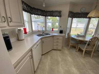 This well cared for home is furnished and includes the golf cart on Lake Fairways Country Club in Florida - for sale on GolfHomes.com, golf home, golf lot