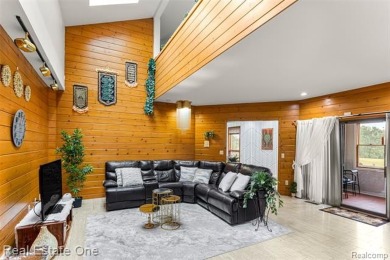 Experience refined contemporary living in this exquisite on Riverview Highlands Golf Club  in Michigan - for sale on GolfHomes.com, golf home, golf lot