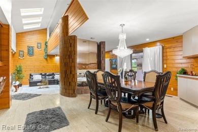 Experience refined contemporary living in this exquisite on Riverview Highlands Golf Club  in Michigan - for sale on GolfHomes.com, golf home, golf lot