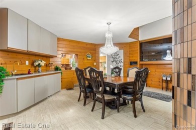 Experience refined contemporary living in this exquisite on Riverview Highlands Golf Club  in Michigan - for sale on GolfHomes.com, golf home, golf lot