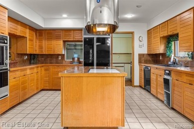 Experience refined contemporary living in this exquisite on Riverview Highlands Golf Club  in Michigan - for sale on GolfHomes.com, golf home, golf lot