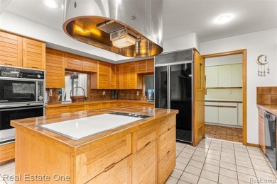 Experience refined contemporary living in this exquisite on Riverview Highlands Golf Club  in Michigan - for sale on GolfHomes.com, golf home, golf lot