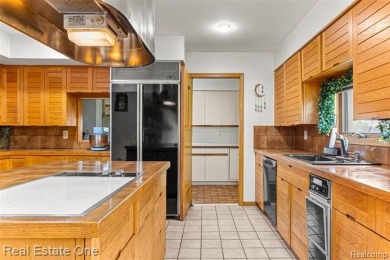 Experience refined contemporary living in this exquisite on Riverview Highlands Golf Club  in Michigan - for sale on GolfHomes.com, golf home, golf lot