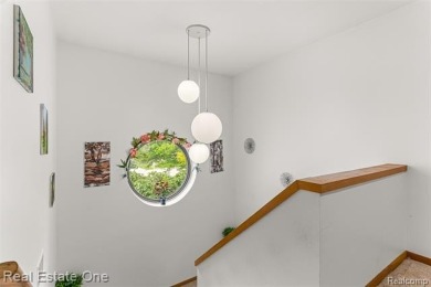 Experience refined contemporary living in this exquisite on Riverview Highlands Golf Club  in Michigan - for sale on GolfHomes.com, golf home, golf lot