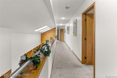 Experience refined contemporary living in this exquisite on Riverview Highlands Golf Club  in Michigan - for sale on GolfHomes.com, golf home, golf lot