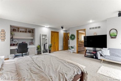 Experience refined contemporary living in this exquisite on Riverview Highlands Golf Club  in Michigan - for sale on GolfHomes.com, golf home, golf lot