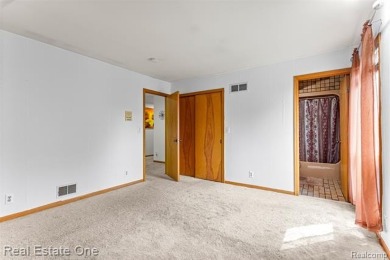 Experience refined contemporary living in this exquisite on Riverview Highlands Golf Club  in Michigan - for sale on GolfHomes.com, golf home, golf lot