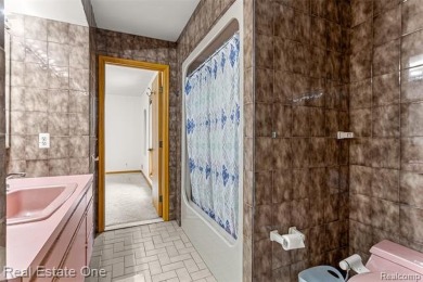 Experience refined contemporary living in this exquisite on Riverview Highlands Golf Club  in Michigan - for sale on GolfHomes.com, golf home, golf lot