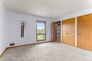 Experience refined contemporary living in this exquisite on Riverview Highlands Golf Club  in Michigan - for sale on GolfHomes.com, golf home, golf lot