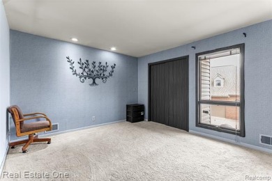 Experience refined contemporary living in this exquisite on Riverview Highlands Golf Club  in Michigan - for sale on GolfHomes.com, golf home, golf lot