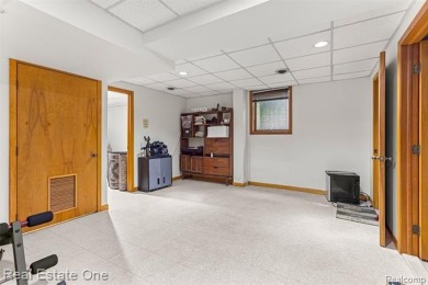 Experience refined contemporary living in this exquisite on Riverview Highlands Golf Club  in Michigan - for sale on GolfHomes.com, golf home, golf lot