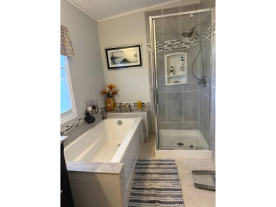 This lovely, manufactured home is in Lake Fairways Country Club on Pine Lakes Country Club in Florida - for sale on GolfHomes.com, golf home, golf lot