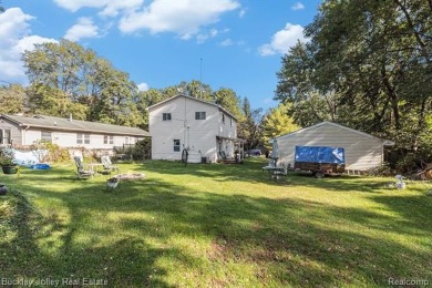 This 2 story colonial on a quarter acre comes with access/lake on Rush Lake Hills Golf Club in Michigan - for sale on GolfHomes.com, golf home, golf lot