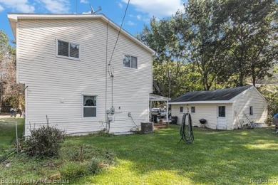 This 2 story colonial on a quarter acre comes with access/lake on Rush Lake Hills Golf Club in Michigan - for sale on GolfHomes.com, golf home, golf lot