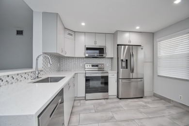 Fully renovated open concept kitchen with s/s appliances, quartz on Wynmoor Golf Course in Florida - for sale on GolfHomes.com, golf home, golf lot