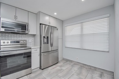 Fully renovated open concept kitchen with s/s appliances, quartz on Wynmoor Golf Course in Florida - for sale on GolfHomes.com, golf home, golf lot