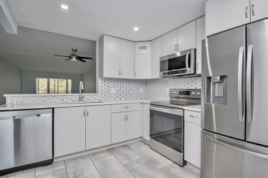 Fully renovated open concept kitchen with s/s appliances, quartz on Wynmoor Golf Course in Florida - for sale on GolfHomes.com, golf home, golf lot