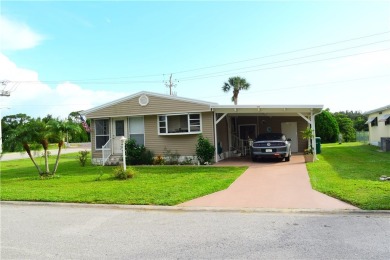 This cozy corner-lot home is full of potential and ready for on Barefoot Bay Golf Course in Florida - for sale on GolfHomes.com, golf home, golf lot