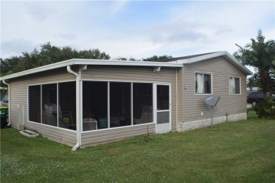 This cozy corner-lot home is full of potential and ready for on Barefoot Bay Golf Course in Florida - for sale on GolfHomes.com, golf home, golf lot