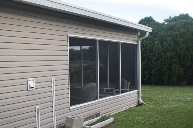 This cozy corner-lot home is full of potential and ready for on Barefoot Bay Golf Course in Florida - for sale on GolfHomes.com, golf home, golf lot