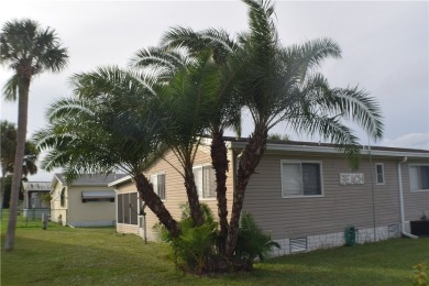 This cozy corner-lot home is full of potential and ready for on Barefoot Bay Golf Course in Florida - for sale on GolfHomes.com, golf home, golf lot