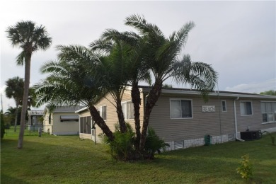 This cozy corner-lot home is full of potential and ready for on Barefoot Bay Golf Course in Florida - for sale on GolfHomes.com, golf home, golf lot