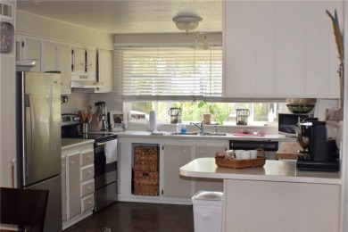 This cozy corner-lot home is full of potential and ready for on Barefoot Bay Golf Course in Florida - for sale on GolfHomes.com, golf home, golf lot