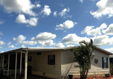 This lovely 2-bedroom, 2-bathroom gem overlooks a picturesque on Lake Henry Golf Club in Florida - for sale on GolfHomes.com, golf home, golf lot