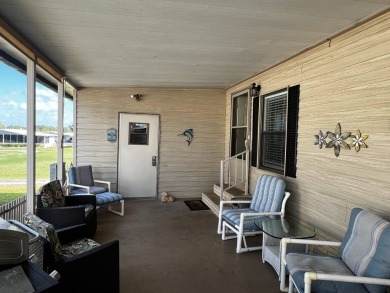 This lovely 2-bedroom, 2-bathroom gem overlooks a picturesque on Lake Henry Golf Club in Florida - for sale on GolfHomes.com, golf home, golf lot