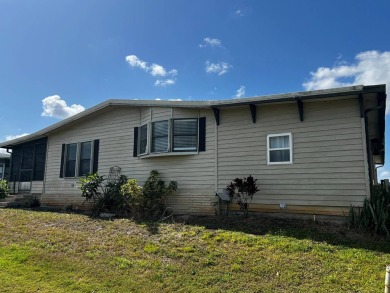 This lovely 2-bedroom, 2-bathroom gem overlooks a picturesque on Lake Henry Golf Club in Florida - for sale on GolfHomes.com, golf home, golf lot
