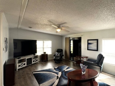 This lovely 2-bedroom, 2-bathroom gem overlooks a picturesque on Lake Henry Golf Club in Florida - for sale on GolfHomes.com, golf home, golf lot
