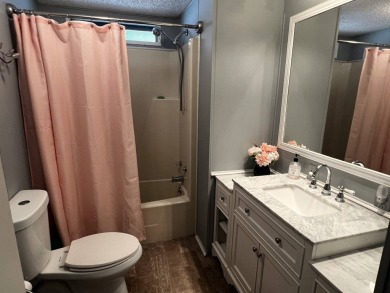 This lovely 2-bedroom, 2-bathroom gem overlooks a picturesque on Lake Henry Golf Club in Florida - for sale on GolfHomes.com, golf home, golf lot