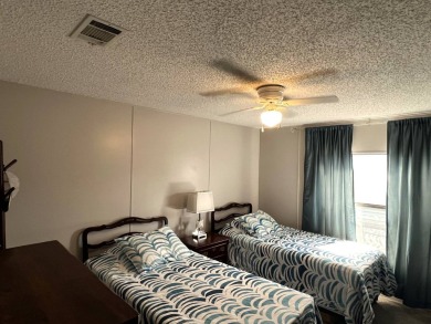 This lovely 2-bedroom, 2-bathroom gem overlooks a picturesque on Lake Henry Golf Club in Florida - for sale on GolfHomes.com, golf home, golf lot