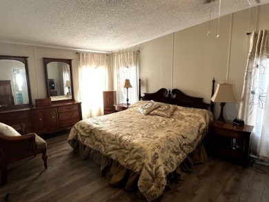 This lovely 2-bedroom, 2-bathroom gem overlooks a picturesque on Lake Henry Golf Club in Florida - for sale on GolfHomes.com, golf home, golf lot