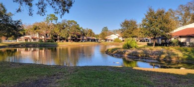 Beautiful end unit condo, located on tranquil pond with serene on Tarpon Woods Golf Club in Florida - for sale on GolfHomes.com, golf home, golf lot
