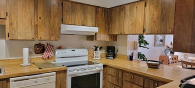 Beautiful end unit condo, located on tranquil pond with serene on Tarpon Woods Golf Club in Florida - for sale on GolfHomes.com, golf home, golf lot