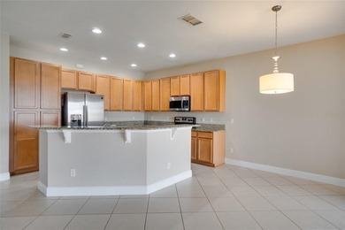 This Eagle Creek townhouse with an upstairs balcony overlooking on Eagle Creek Golf Club in Florida - for sale on GolfHomes.com, golf home, golf lot