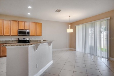 This Eagle Creek townhouse with an upstairs balcony overlooking on Eagle Creek Golf Club in Florida - for sale on GolfHomes.com, golf home, golf lot