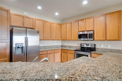 This Eagle Creek townhouse with an upstairs balcony overlooking on Eagle Creek Golf Club in Florida - for sale on GolfHomes.com, golf home, golf lot